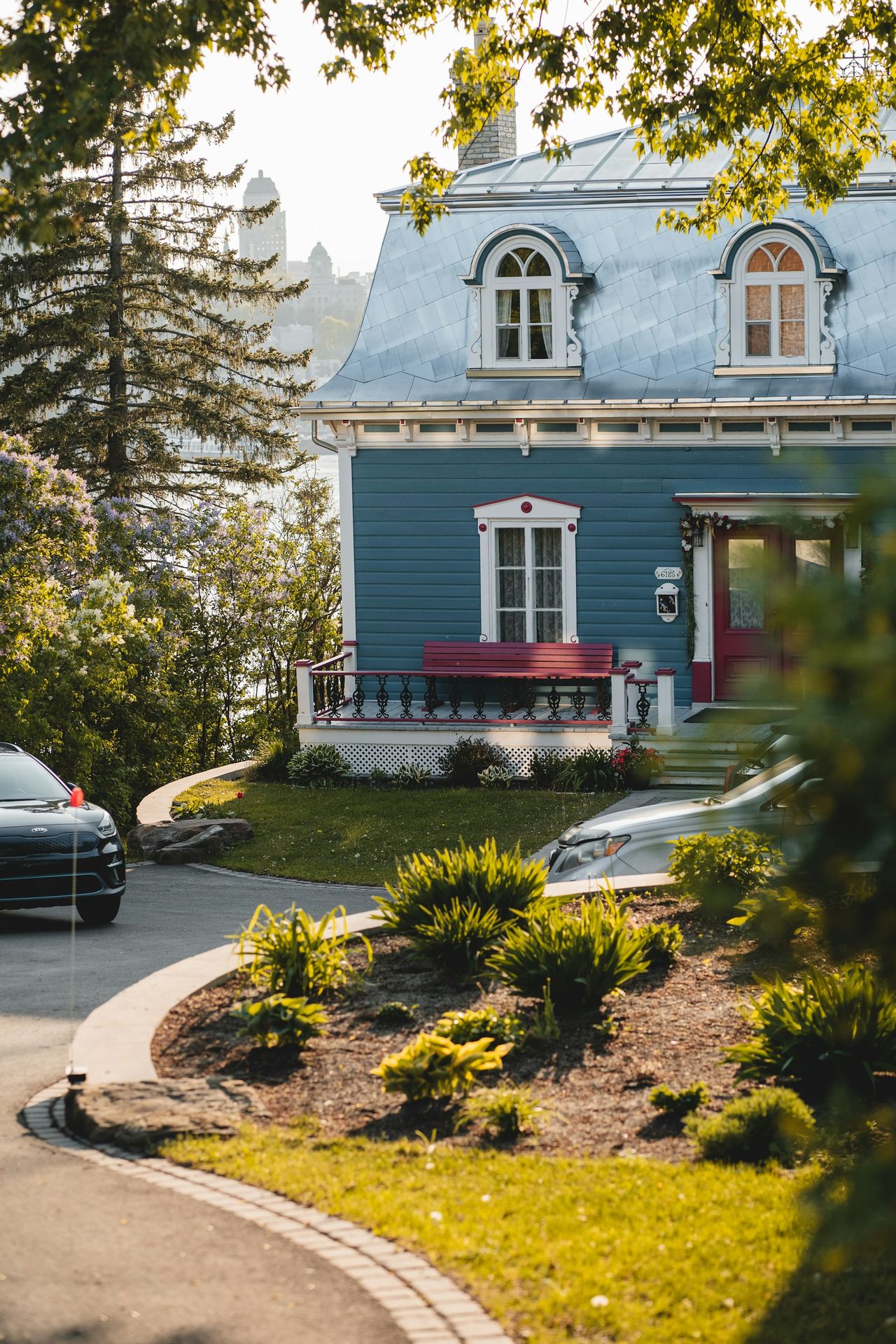 a blue house with a red bench in front of it